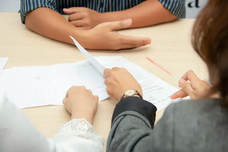 Close up of three people interviewing for grad school